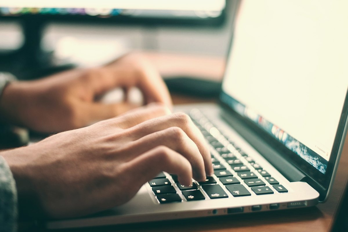 Person working at a laptop, the usual starting point before a batch print job